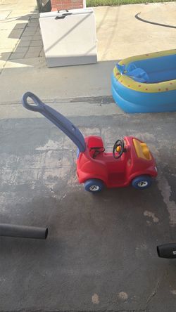 Toddler pushing car