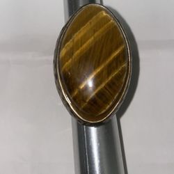 Super large tiger eye ring in a spotted brass tone band.  Size 7