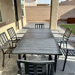 Alyah Extendable Powder Coated Steel Dining Table with 8 Stacking Patio Dining Armchairs