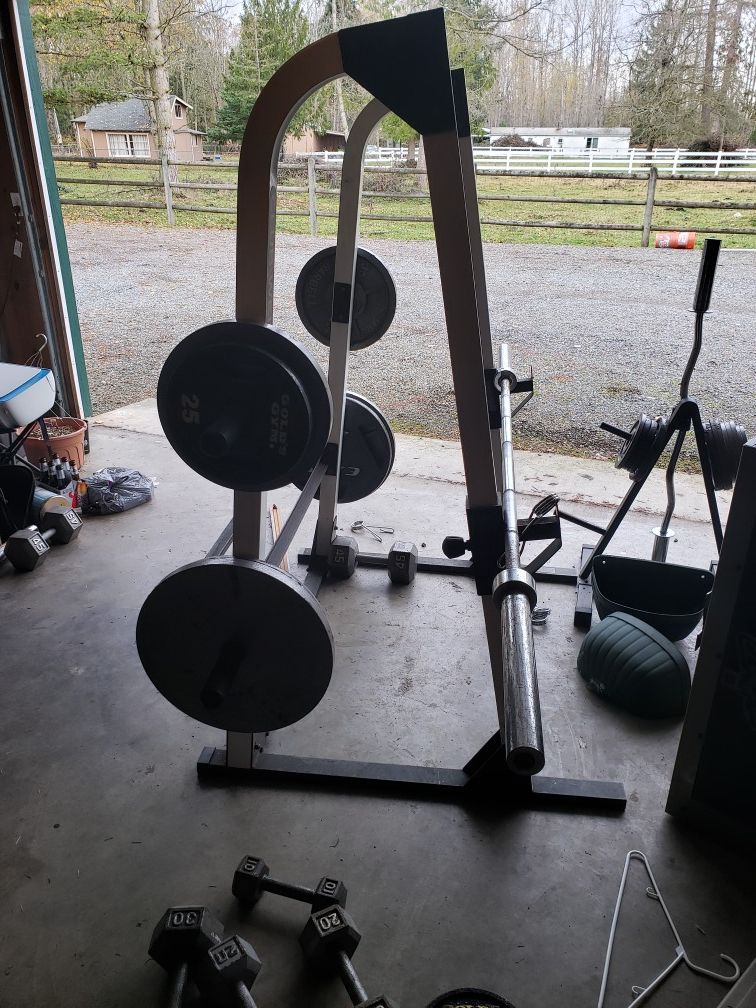 Weight set including , 45, 35, 25, and 10 and 15 plates. Squat rack, and Olympic bar stand.