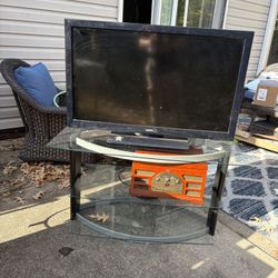 All Glass Entertainment Center, Sanyo 42" LED TV, Brown Record Player Will Not Be Available 