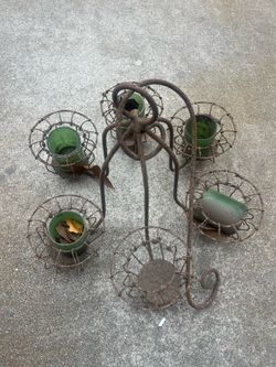 Rustic outdoor chandelier missing one candle holder