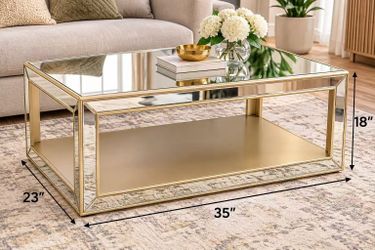 Mirrored Gold Coffee Table – 35” x 23” x 18” Beautiful modern coffee table with a mirrored glass top and elegant gold-tone frame. Features a spacious