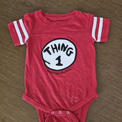 Dress up your little one in this adorable Dr. Seuss Thing 1 one-piece in vibrant red. Perfect for both baby boys and girls aged 12 months, this outfit