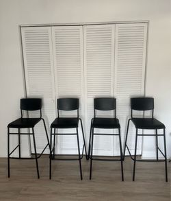 Ikea - STIG - black bar stool chairs .