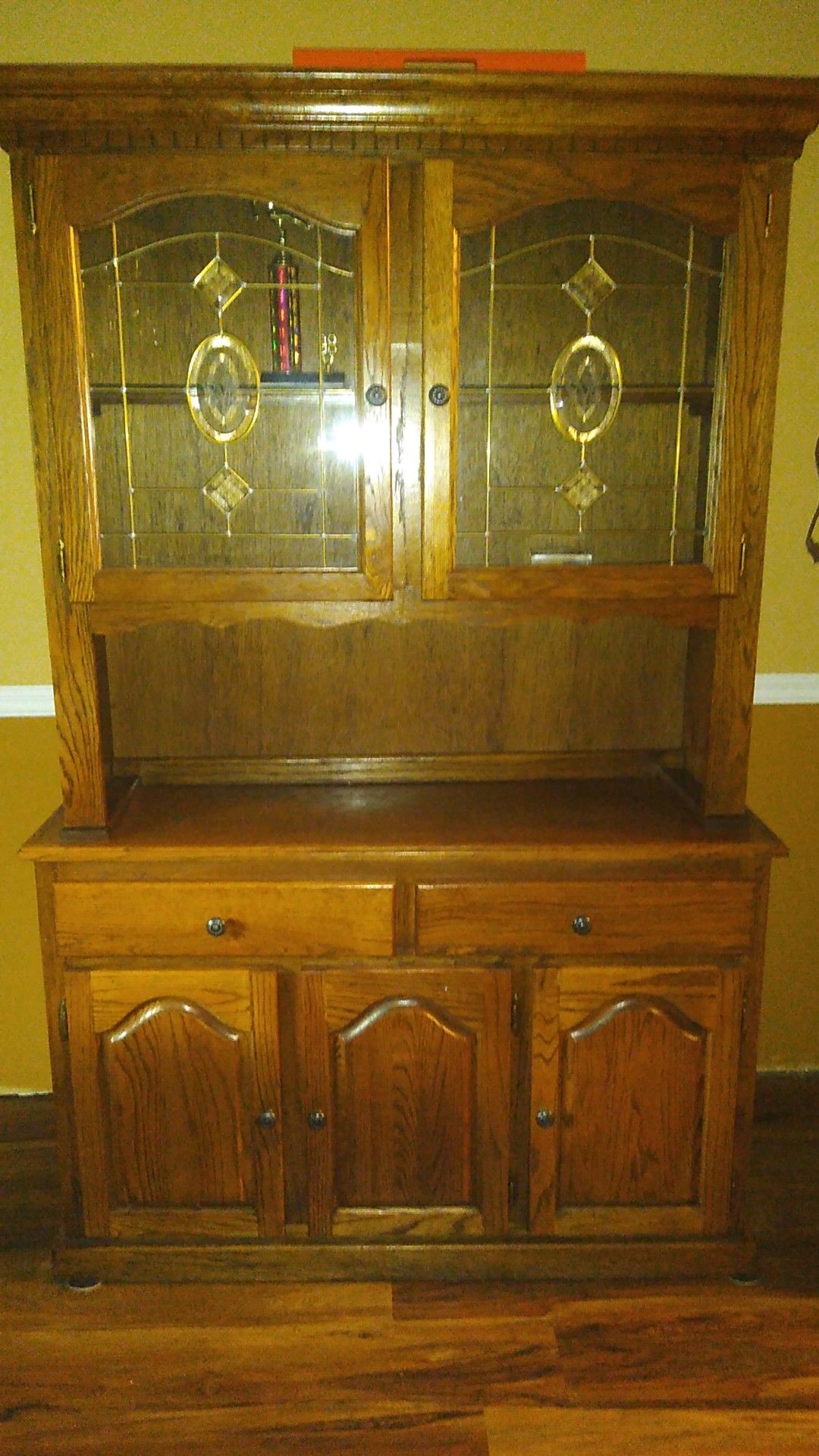 Beautiful china cabinet withh leaded glass doors and lighted upper cabinet.