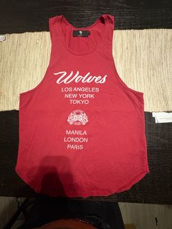 Women’s Medium Red Darc Sport  Wolves Club tank top with white text reading 'Wolves', 'LOS ANGELES', 'NEW YORK', 'TOKYO', 'MANILA', 'LONDON', 'PARIS' 