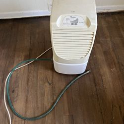 Whirlpool dehumidifier with drainage hose.