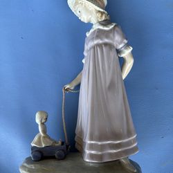 Lladro girl pulling cart wagon