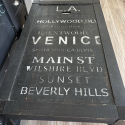 Coffee Table 19H 48L 28 W.  Wooden top with metal legs.  Black with white lettering