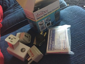 Travel outlet plugs, emergency blanket and step down converter