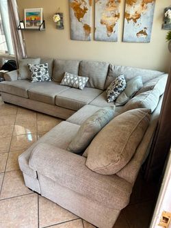 Gorgeous Beige sectional couch with deep seating from Jerome’s . DELIVERY AVAILABLE