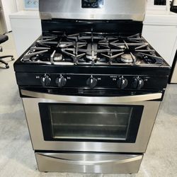 Kenmore stainless steel gas stove with a receipt for a 90-day warranty