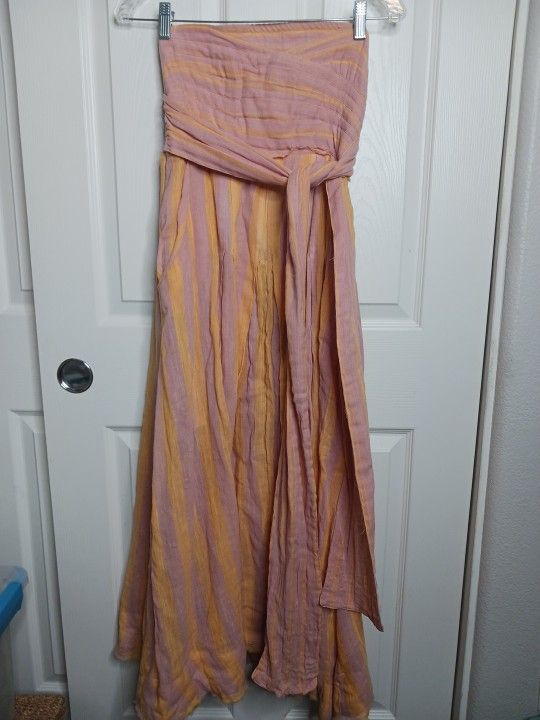 The Free People "Stripe Me Up" Yellow & Pink Strapless Midi Dress in size XS is a whimsical and lightweight dress designed for various occasions such