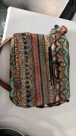 Sakroots Artist Circle crossbody bag is crafted from coated canvas and features a vibrant, multi-colored geometric pattern.Brand: SakrootsMaterial: Co