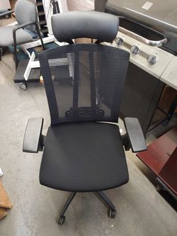 Mesh back, fabric seat and leather headrest.