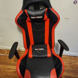 Red and black gaming chair with foot rest
