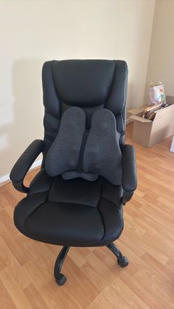 Black rolling office chair and ergonomic seat cushion