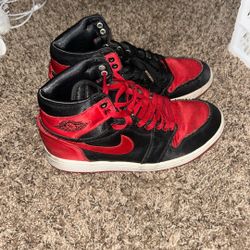 This is a pair of Nike Air Jordan 1 Retro High OG "Satin Bred" sneaker