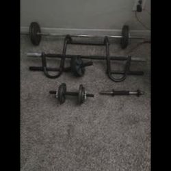 15 lb curling Bar w /two Dubbels and Ab Roller and Pull-up Bar. (Weights Included)