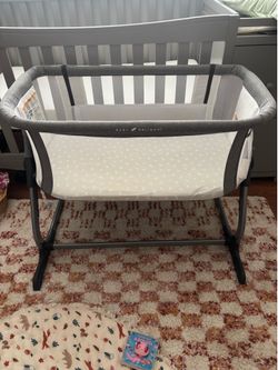 Baby Delight bassinet with sheets and mattress cover