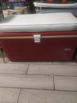 Vintage igloo cooler with seat pad on top