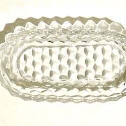  glass dish is a Fostoria American pattern oval celery or relish dish. This clear, heavy pressed glass pattern features a distinctive cube or diamond 