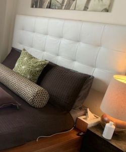 Platform bed with leather headboard and low side tables