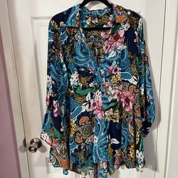 Women’s Size 18W Flowy Tunic LengthTop with long sleeves.  The sleeves have 4 buttons.  Color Blue with floral design.  Made of 100% Rayon.  Brand new