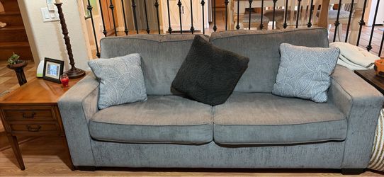 Gray Sofa sleeper with decorative pillows