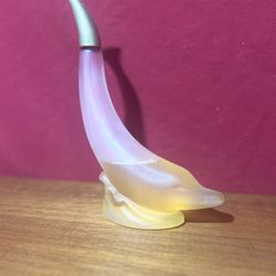 vintage Avon bottle shaped like a dolphin.
