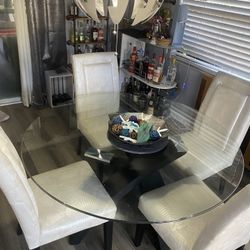Glass dining room table with four chairs