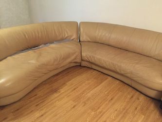 Curved sectional with 2 resting chairs an ottoman