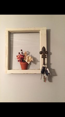 Wooden framed wall hanging. With a hook to hold keys, mask, etc