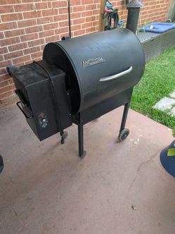 Traeger pellet grill with wood pellets included and cover.
