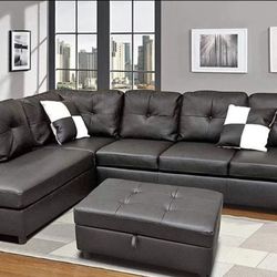 Black leather sectional couch and ottoman
