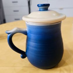 New, never used smooth, curved thick ceramic mug with strainer and lid.