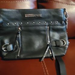 Harley-Davidson black leather shoulder or crossbody bag with studs, zippers, and buckle detailing. 
This particular design appears to be from an older