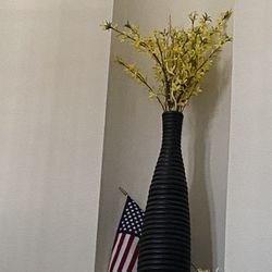 big black vase with decor flowers 
