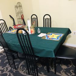 Nice dining table set with 6 chairs and a matching black rug
