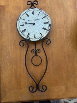 Vintage-style wall clock with Roman numerals. Keeps good time. 30.5 long and 12 inches wide.