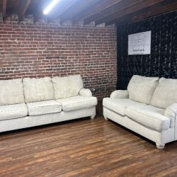 Delivery Available beige couch + loveseat w pull out bed