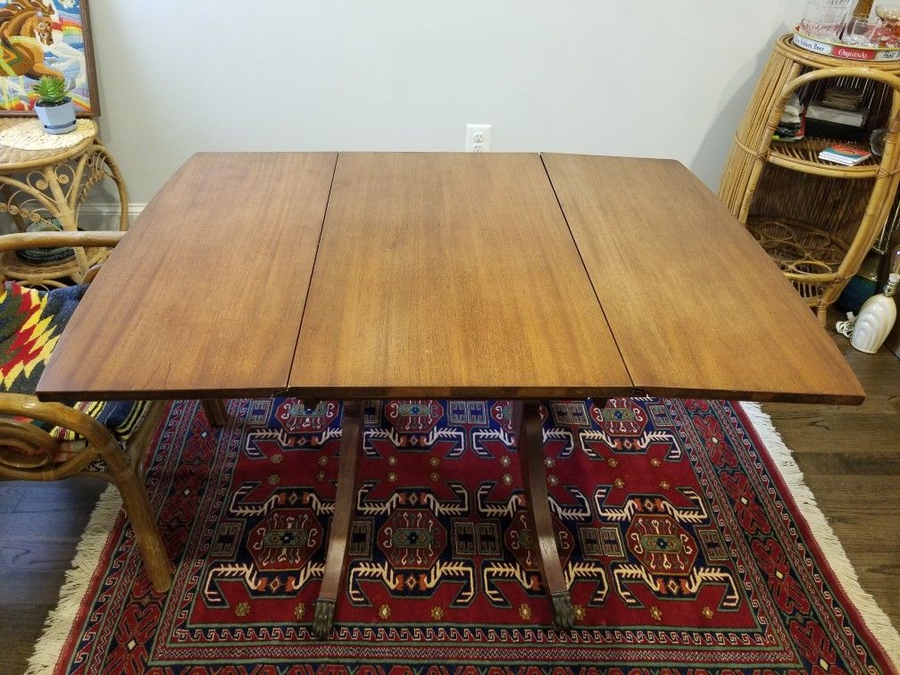 Beautiful vintage drop leaf table with rolling metal claw legs