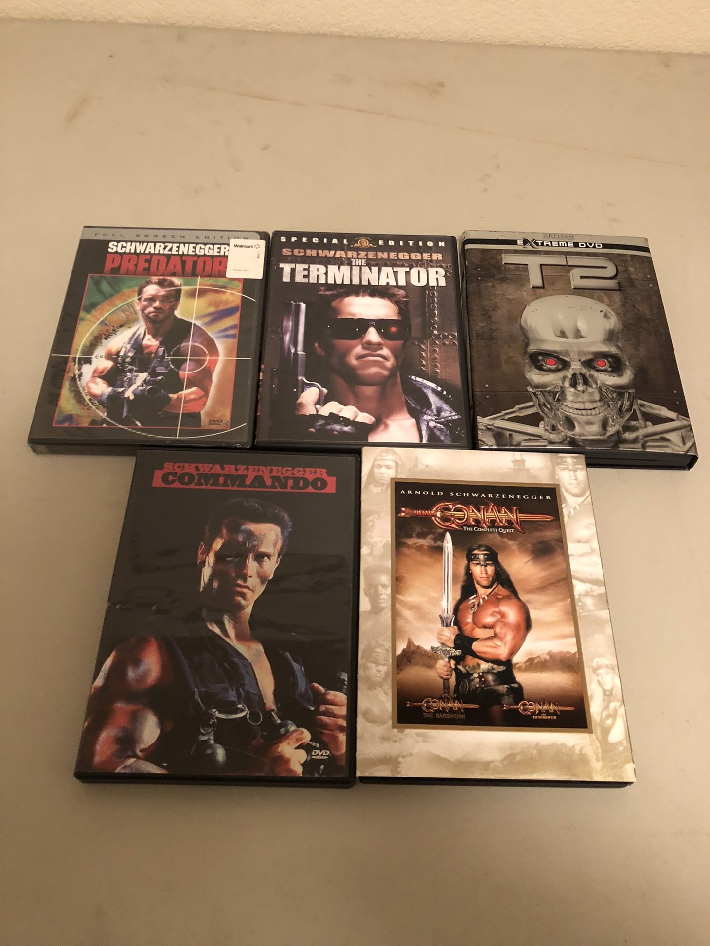 5 Arnold Schwarzenegger DVDS $2. Ea.