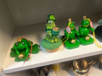 festive St. Patrick’s Day frog figurines feature various green and gold designs