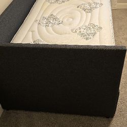 Grey Twin bed with two drowers and mattress