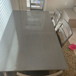 Ashley - dinning table with chairs and a bench with protector