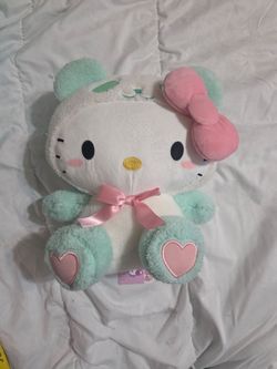 Sanrio Hello Kitty plush toy from a Round 1 arcade collaboration, featuring the character in a mint-colored panda costume.