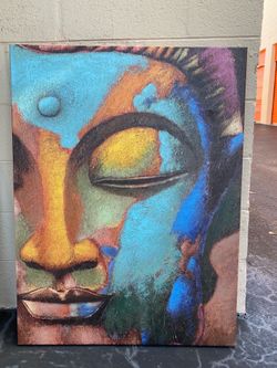Colorful abstract canvas painting of Gautama Buddha's face.