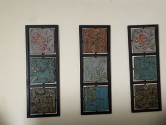 monstera leaf tabletop sculpture and Benzara metal floral wall plaques.